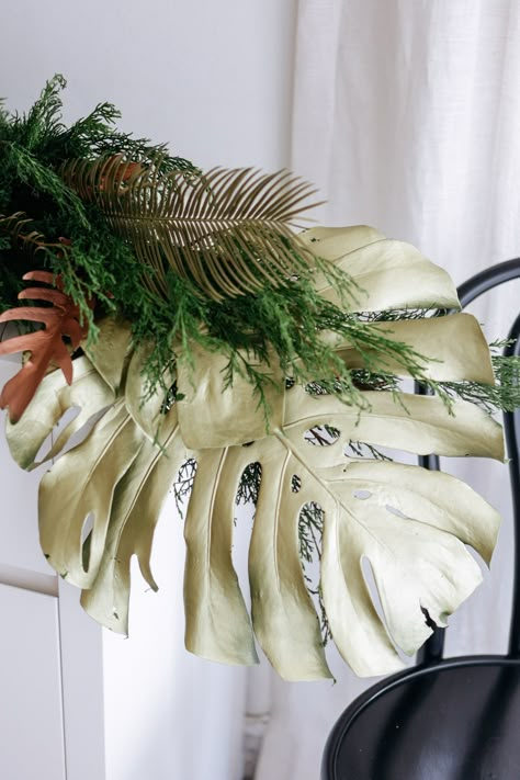 Gold painted monstera leaf with pine garland decoration for Christmas Jungle Christmas Decorations, Tropical Holiday Decor, Tropical Holiday Decorations, Palm Leaf Christmas Tree, Tropical Christmas Garland, Palm Beach Christmas Decor, Tropical Fall Decorations, Christmas Tropical, Jungle Christmas