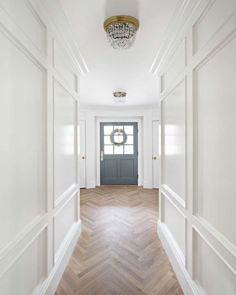 Herringbone flooring and beautiful paneled walls painted Benjamin Moore Simply White. The Fox Group. #benjaminmooresimplywhite #interiordesign #thefoxgroup The Fox Group, Fox Group, Timeless Interior Design, Foyer Entrance, Herringbone Wood Floor, Herringbone Wood, Timeless Interior, Herringbone Floor, White Paint Colors