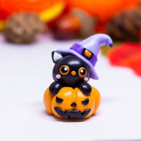 Cute figurine of witch cat on a scary pumpkin crafted from ploymer clay and glazed with UV resin for extra shine and durability. ♥ All my creations are handmade in polymer clay, ensuring that no two are exactly alike. ♥ Measuring 3 cm * 2.5 cm, it's the perfect size for a keychain or a small collectible.  ♥ If you prefer a larger size, the desk buddy measures 5 cm * 4 cm. ♥ What you see in the pictures is what you will get, not a cheap imitation, nevertheless they are handmade, so they can be slightly different in some small detail. ♥ If you like any of my handmade creations but would prefer a different size or color, I'm happy to accommodate your requests. I can modify existing items or create brand new ones based on your ideas. Contact me to discuss your custom order! ♥ Thank you for vis Polymer Clay Ideas Halloween, Polymer Clay Halloween Charms, Halloween Clay Figures, Clay Ideas Halloween, Cat Polymer Clay, Polymer Clay Charm Ideas, Polymer Clay Witch, Pumpkin Cat, Clay Halloween