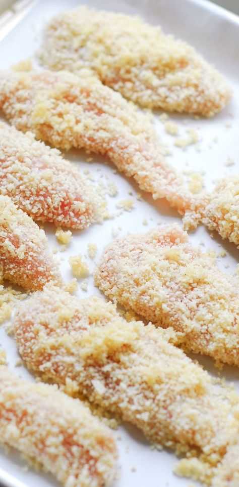 Chicken tenders on a baking sheet Crispy Baked Chicken Tenders, Chicken Tenders Oven, Panko Chicken Tenders, Chicken Tender Recipes Baked, Baked Chicken Tenderloins, Crunchy Chicken Tenders, Chicken Fingers Baked, Oven Baked Chicken Tenders, Baked Breaded Chicken