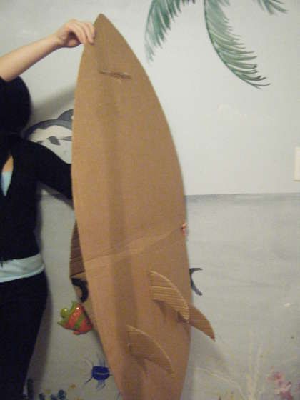 Corrugated Cardboard Surfboard: Diy Surf Board Prop, How To Make A Surfboard, Diy Cardboard Surfboard, Diy Surfboard Decor Party, Diy Surfboard Decor Cardboard, Diy Surfboard Decor, Cardboard Surfboard, Surfer Costume, Surfer Party