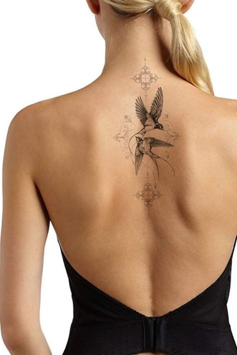 Learn the swallow tattoo meaning, its belonging to different cultures, and to whom such a design will suit the most. Bonus: the best unique designs inside. Back Tattoo Birds Women, Back Tattoo Women Bird, Feminine Swallow Tattoo, Sparrow Tattoo Women, Elegant Bird Tattoos, Bird Back Tattoos For Women, Birds Back Tattoo, Back Bird Tattoo, Timeless Tattoos For Women