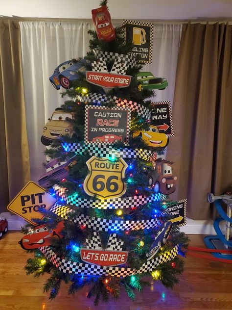 Male Christmas Tree Ideas, Cars Christmas Tree Disney, Boys Christmas Trees, Cars Theme Christmas Tree, Lightning Mcqueen Christmas Tree, Disney Cars Christmas Tree, Race Car Christmas Tree Ideas, Pixar Christmas Tree, Car Themed Christmas Tree