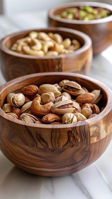 Three wooden bowls on a table filled with various nuts, including pistachios and cashews stock image Wooden Dinnerware, Home Utensils, Food Set Up, Wood Business, Wooden Salad Bowl, Nut Bowl, Vector Portrait, Party Apps, Wood Bowls