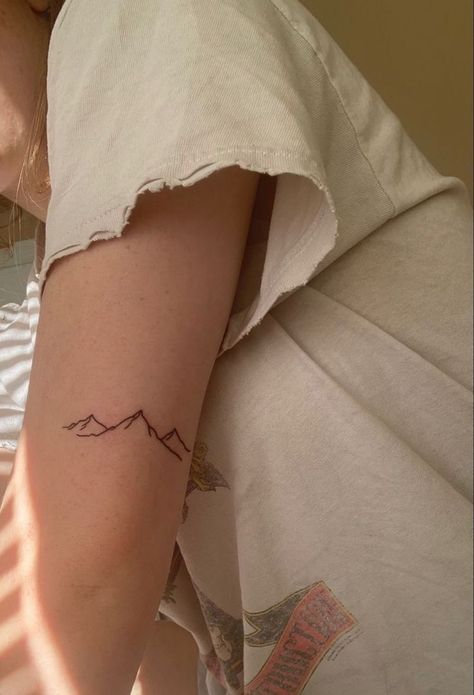 The Art of Travel: Exploring the World of World Traveler Tattoos | Travel Tattoos Inspiration Mountains On Collar Bone Tattoo, 3 Mountain Tattoo, Mountain Range Line Art, Mountain Tattoo On Back Of Arm, Mountains Small Tattoo, Upper Tattoos Arm, Tattoo Of Mountains, Mountain Tattoo Placement Ideas, Mountain Tatoos Small Arm