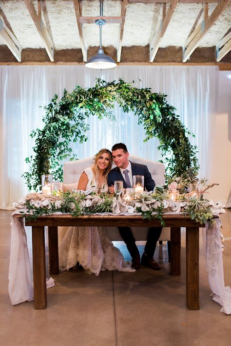 Click to see more from this neutral, coastal inspired wedding! Sweetheart table using an infinity arch and white draping as the backdrop.  #sweethearttablewedding #sweethearttablebackdrop #orlando Sweetheart Table Wedding Backdrop, Wedding Couple Table, Sweetheart Table Backdrop, Bride Groom Table, Simple Beach Wedding, Head Table Decor, Head Table Wedding, Neutral Wedding Colors, Wedding Reception Backdrop