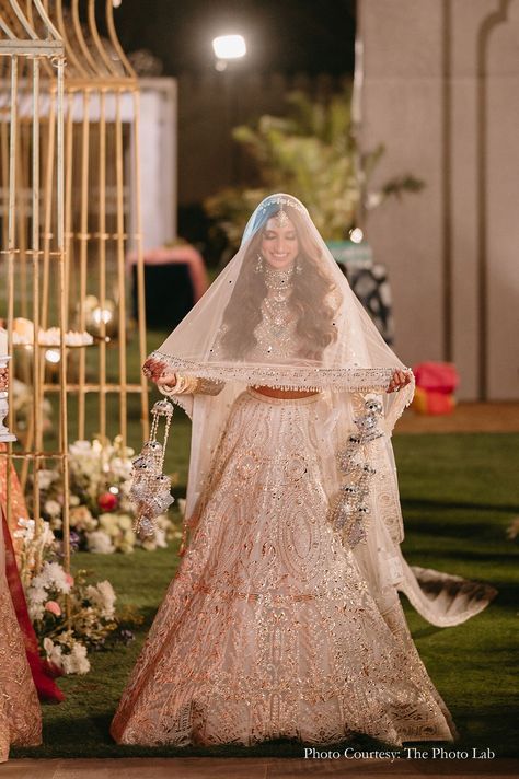 bride, ivory wedding lehenga, veil, bridal beauty, wedding glamour, ethereal elegance, wedding fashion, bridal inspiration, Indian wedding trends, stunning bride, wedding day, regal bride, ivory elegance, wedding attire, enchanting bride, bridal look bridal veil longs veils grace indian wedding indian bride wedding bride wedding sutra traditional fashion, bridal veil fashion, bridal fashion, veils, traditional veils white lehenga traditional look bridal white lehenga Bridal Entry With Veil Indian, Lehenga Veil Indian Bridal, Bridal Veil Indian, Indian Wedding Veil, Poolside Wedding Ceremony, Regal Bride, Lehenga Traditional, Veil Fashion, Fairmont Jaipur