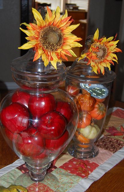 Fall decor....Apothecary Jars with apples, little pumpkins and sunflowers. Fall Decor With Apples, Apple Bucket Fall Decor, Apples And Sunflowers Decor, Large Glass Vase Filler Thanksgiving, Apothecary Jar Ideas, Candy Corn Apothecary Jars, Apothecary Jars Decor, Jar Fillers, Apothecary Decor