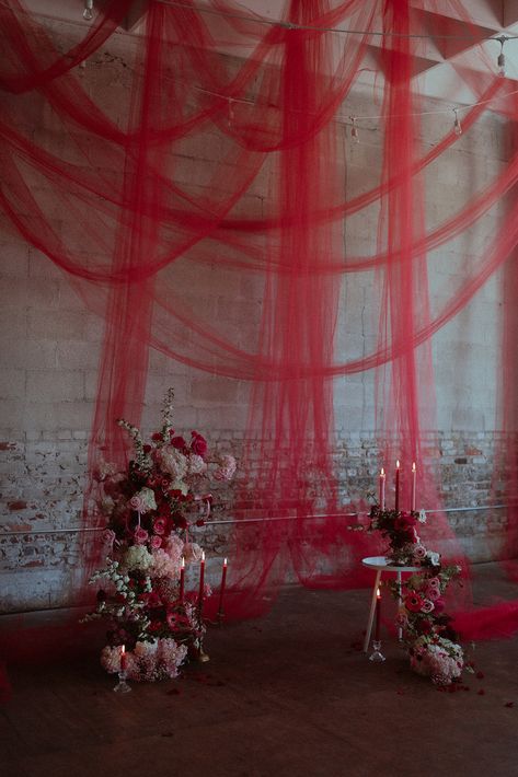 Gothic Red and Pink Haus of Junon Wedding Styled Shoot with Red Draping for LGBTQIA+ y’ALL Workshop in Birmingham, Alabama — The Rose Reflective Ecentric Florals and Candles by Poppy and Snail Red Party Aesthetic Ideas, Moody Lighting Wedding, Red Backdrop Ideas, Dracula Wedding, Red And Pink Backdrop, Red Halloween Party, Red Rose Party Theme, Pink And Red Party Decorations, 90s Wedding