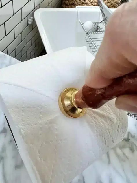 Pressing an embossing tool into the end of a roll of toilet paper. Embossed Toilet Paper, Toilet Paper Embossing, Spare Toilet Paper Holder Ideas, Toilet Paper Stamping, Toilet Paper Folding Ideas, Toilet Paper Stamp, Toilet Paper Origami, Hotel Cleaning, Jetted Bath Tubs