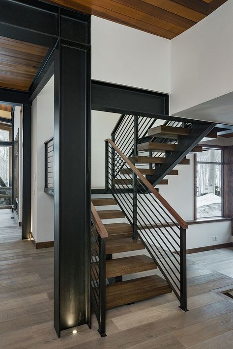 A modern floating staircase by Kogan Builders, Inc has wood open treads and a single central metal stringer. has metal railing with top wooden rail. c channel beams supports second floor and add industrial feel to this mountain home Mountain Modern Home, Open Stairs, Diy Staircase, Open Staircase, Metal Stairs, Floating Stairs, Floating Staircase, Industrial Interior Design, Staircase Railings