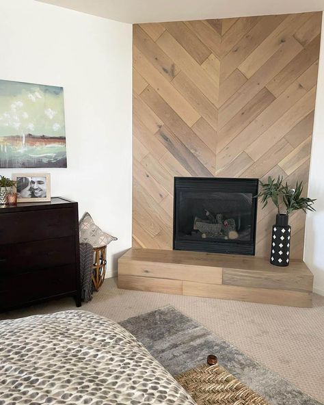 Wood-look shiplap in a herringbone pattern with an inset black fireplace creates an eye-catching feature wall. A patterned black and white vase sits on the wooden tile hearth. Wood Tile Wall Accent, Vertical Shiplap Fireplace Wall, Herringbone Shiplap, Tile Hearth, Herringbone Fireplace, Wood Wall Tiles, Inset Fireplace, Black And White Vase, Black Fireplace