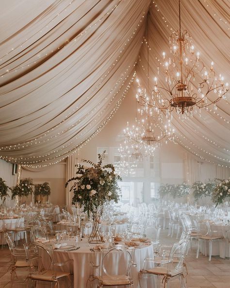 The clear chairs with the lights create a magical display. Clear Chairs Wedding, Clear Tent With Lights Wedding, Clear Tent Wedding Dance Floor, Clear Tent Reception, White Tent Wedding Reception Chandeliers, Clear Tent Wedding Chandeliers, Clear Chairs, 65th Anniversary, Ceiling Treatments