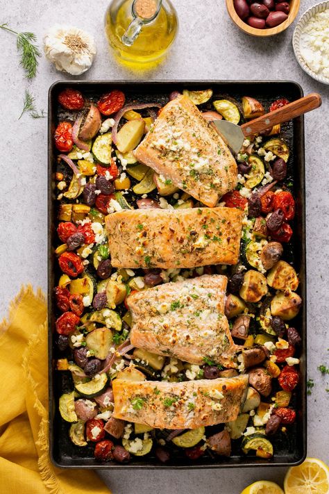 This easy Greek Salmon recipe features tender, flakey fish smothered in a flavorful Greek marinade and cooked on one pan in the oven! Dinner Ideas Paleo, Mediterranean Sheet Pan Dinners, Italian Chicken Recipes Easy, Greek Salmon Recipe, Mediterranean Sheet Pan, Greek Marinade, Greek Salmon, Salmon And Veggies, Greek Chicken And Potatoes