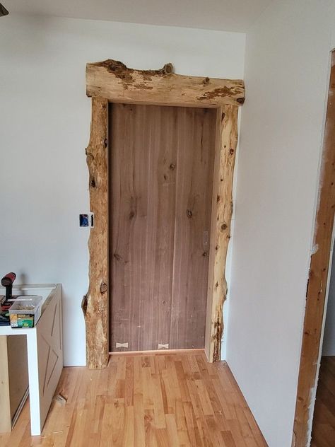 Door Framing Ideas, Live Edge Door Trim, Live Edge Trim Molding, Live Edge Baseboard, Cedar Trim Interior Wood, Rustic Door Trim, Rustic Trim Ideas, Live Edge Trim, Rustic Window Trim