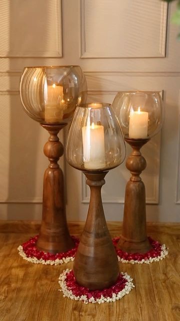 The Decor Kart on Instagram: "Majestic Floor Candle Holders 🕯️ Create an enchanting aura this festive season with our floor candle holders. A beautiful combination of glass top sitting on a hand-carved wood base which can be a perfect accessory for your home’s decor. When lighted, hurricane light uplifts the ambiance of any room with its natural look glowing in candle light and makes it an absolute head turner! Tap Shop Now for more information ℹ️" Floor Standing Candle Holders, Floor Candle Stands, Wooden Pillar Candle Holders, Wooden Candle Stand, Wooden Pillars, Floor Candle Holders, Candle Stands, Floor Candle, Metal Furniture Design