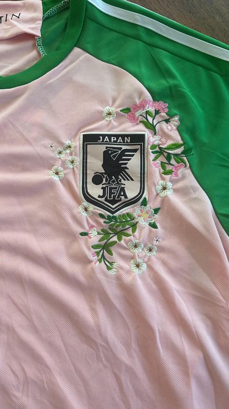 🌸 Unique custom creation, embroidered with care over several days. Designed and crafted by Mark (me!) from footballembroideryAU | Limited availability | Thank you for supporting my work and passion 🌸 🌸 Japan X Nigo Third Football Jersey in Pink - Customised with Hand-Stitched Cherry Blossom Embroidery | Unisex 🌸 🌸 Perfect for fans of Japanese football, anime enthusiasts, cherry blossom admirers, or anyone who loves streetwear and urban fashion! 🌸 🌸 The inspiration behind this design comes Cute Volleyball Jerseys, Floral Embroidery On Shirt, Soccer Kits Design, Custom Football Jerseys, Soccer Jersey Aesthetic, Football T Shirt Designs, Japan Soccer Team, Japan Jersey, Japanese Jersey