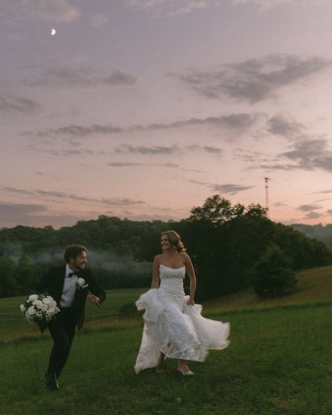 Bride and groom running under the moonlight together. Beautiful wedding photos at night. Wedding photos with the colorful dark sunset. Bright moon in the sky. Running in the grass under moonlight. Candid wedding photography. Wedding Running Photo, Wedding Pictures At Night, Bride And Groom Candid Photos, Wedding Photos Running, Late Night Wedding Photos, Wedding Photos On The Beach, Wedding Photo Ideas Candid, Night Time Wedding Photos, Candid Wedding Photos Natural