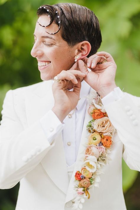 The groom dazzled in a blinged-out white suit adorned with a floral lapel. | Image by La Vie Studios Floral Suits For Men, Luxury Wedding Suit With Floral Embroidery, Formal White Suit And Tie Accessories With Floral Print, Elegant Floral Print Suit And Tie Accessories For Groom, Groom Suit Flower, Suit With Flowers, Flower Crown Outfit, Dresscode Ideas, Floral Suit Men