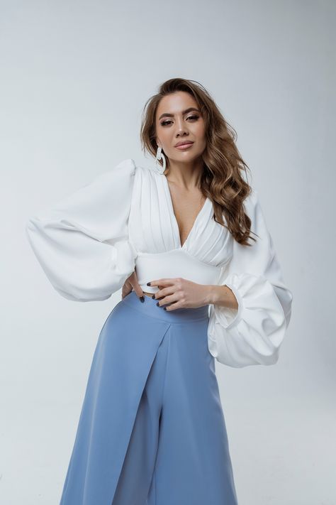 This puff-sleeve V-neck blouse is the epitome of elegance. The puffed sleeves create a flattering silhouette, while the backless design adds a touch of sexiness. Dress it up with high-waisted culottes from our collection. #puffsleeveblouse #vneckblouse #backlessblouse #femininefashion #sophisticatedstyle #elegantblouse #statementtop High Waisted Culottes, Kibbe Romantic, Puff Sleeves Top, Backless Blouse, Wear Store, Satin Long Sleeve, Backless Design, Elegant Blouses, Silk Slip Dress