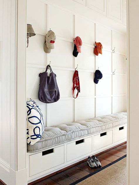 Evenly spaced hooks and an ultra comfy bench cushion make this once-crammed entryway open and inviting. Bins beneath the built-in bench provide hidden storage, while a wall of wainscoting gives the area upscale style./ Comfy Bench, Mudroom Storage, Mudroom Storage Bench, Mud Room Storage, Mudroom Design, Entry Way Design, Laundry Mud Room, Built In Bench, Mudroom Bench