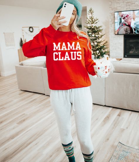 Get into the holiday spirit with our Mama Claus sweatshirt, the ultimate Christmas must-have for moms. Crafted from a super soft and cozy material, this sweatshirt guarantees a snug fit and all-day comfort. Perfect for festive gatherings or snuggling up by the fire, it's the ideal companion during the most wonderful time of the year. Embrace the magic of Christmas in style, and let the world know you're a proud Mama Claus, spreading love and warmth with every wear. Unisex fit Stay with your true Mama Claus Sweatshirt, Ultimate Christmas, Mama Tee, Oversized Graphic Tee, The Magic Of Christmas, Magic Of Christmas, Trendy Graphic Tees, Mama Sweatshirt, Christmas Mom