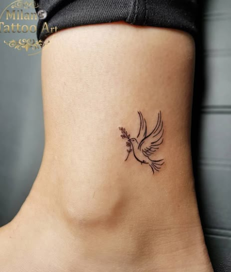 Mini Dove Tattoo design Bird Tatoos Woman Wrist, Small Dove Tattoo Design For Women, Dove With Olive Branch Tattoo Simple, Dainty Dove Tattoo, Dove Flying Tattoo, Angel Tattoo Placement, Cross With Birds Tattoo, Dove Hand Tattoo, Dove Tattoo Design For Women