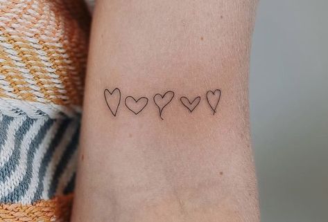 Tattoo by @vibetattoo.ut on instagram Heart Tattoos From Family, Women Family Tattoos, Family Draw Heart Tattoo, Womens Minimalist Tattoos, Family Draws Hearts Tattoo, Dainty Tattoo Ideas For Women, Line Of Hearts Tattoo, Meaningful Family Tattoo Ideas For Women, Small Tattoo Family