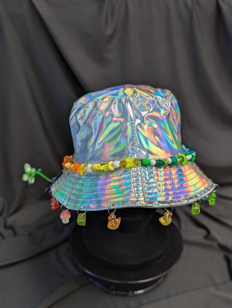 -hat color - silver -bead color - rainbow -charm color - rainbow -unisex adult size -inner circumference - 22.5in -crown dip - 3in -brim - 2.25in -NOT machine washable -Perfect for raves and outdoor festivals! Shipping within the US USPS First Class Package 3-9 days USPS Priority Mail 1-5 days USPS Priority Mail Express 1-3 days Shipping International  USPS First Class Mail International  -Varies- USPS Priority Mail International 6-14 days USPS Priority Mail Express International 3-9 days Shipping times are estimated, NOT GUARENTEED.  +International buyers are responsible for all import fees+ +Orders of $50+ may require signature confirmation upon delivery+ Edc Orlando, Rainbow Festival, Fuzzy Bucket Hat, Edm Fashion, Kidcore Aesthetic, Rave Babe, Rainbow Ombre, Rave Accessories, Festival Diy