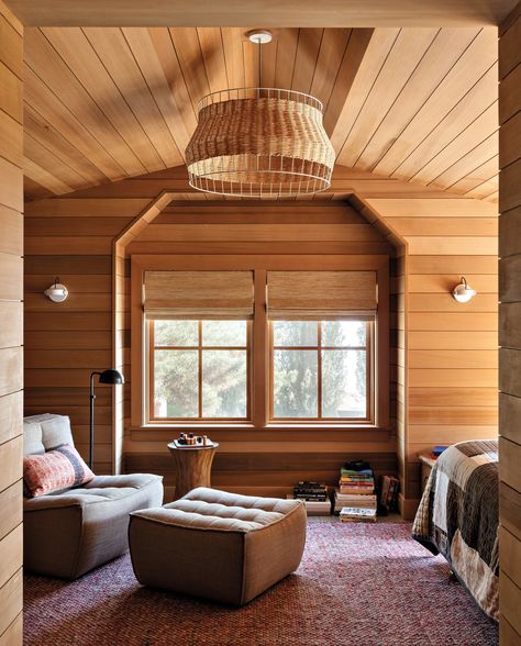 The daughter’s sleeping porch-style bedroom includes a sitting area with a chair and ottoman by Ethnicraft. Lighting fixtures include a Blu Dot pendant, Visual Comfort & Co. floor lamp and RBW wall sconces. Hoedemaker Pfeiffer, Bainbridge Island Washington, Porch Styles, Woven Dining Chairs, Sleeping Porch, Artisan Furniture, Rustic Retreat, Bainbridge Island, Old Farm Houses