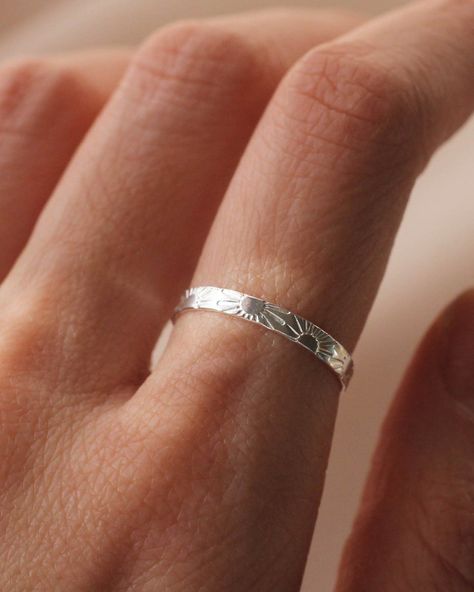 Capture the morning's golden glow with this delicate Silver Sunrise Thin Band Ring. Crafted from sterling silver, each ring features unique, hand-stamped suns. Due to this handcrafted process, each design is slightly different, making your ring truly one-of-a-kind. Available in sizes 4-12 with a width of 2mm. Diy Silver Rings, Perfect Meaning, Simple Ring Design, Surf Jewelry, Bali Jewelry, Silver Jewelry Diy, Silver Rings Simple, Silver Ring Designs, Stamped Rings