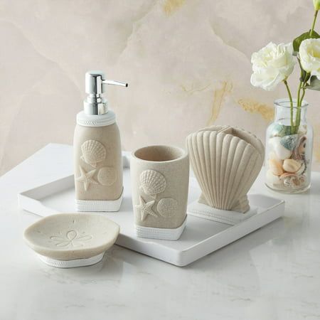 Bring the seashore to your bathroom with bathroom accessory set. This lovely handcrafted resin collection is luxurious, stylish, and helps keep your bathroom decor clean, fresh, and organized. The set includes: A tumbler, lotion/soap dispenser, toothbrush holder and soap dish. Accessory collection is designed with an and Each piece is hand crafted in a durable resin. Easy to wipe clean and made to last a lifetime. This ultra-luxurious collection will surely add contemporary charm to your bathroo Bathroom Beach Theme, Small Coastal Bathroom, Shell Bathroom, 4 Piece Bathroom, Coastal Bathroom Decor, Beach Bathroom Decor, Brown Bathroom, Coastal Bathrooms, Bathroom Accessories Sets