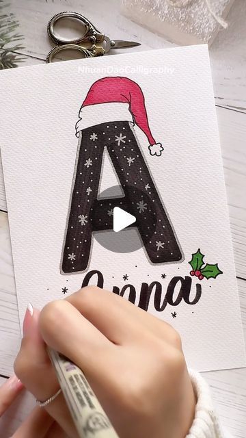 Nhuan Dao✨Calligraphy & Lettering❤️ on Instagram: "✍️ Write Your Name in Festive Christmas Style! 🌟
.
.
.
🌟FREE Gift For You:
Do u Want to Try Your Hand at Brush Lettering and Calligraphy? Download This FREE WORKSHEET : “Master 8 Basic Stroke Of Brush Lettering” For Beginners
👉You Can Find The Link in My Bio or Visit: nhuandaocalligraphy.com
.
.
.
#NhuanDaoCalligraphy #namelettering #Calligraphy
#BrushLettering #ModernCalligraphy #HandLettering #Lettering #Handwriting #Writingname #WriteYourName
#Gift #DIY #artreels #reels" December Calligraphy Hand Lettering, Christmas Letter Ideas Writing, Christmas Card Ideas Drawing, Christmas Doodle Art, Simple Christmas Card Ideas, Christmas Gift Drawing, Christmas Hand Lettering, Lettering For Beginners, Merry Christmas Lettering