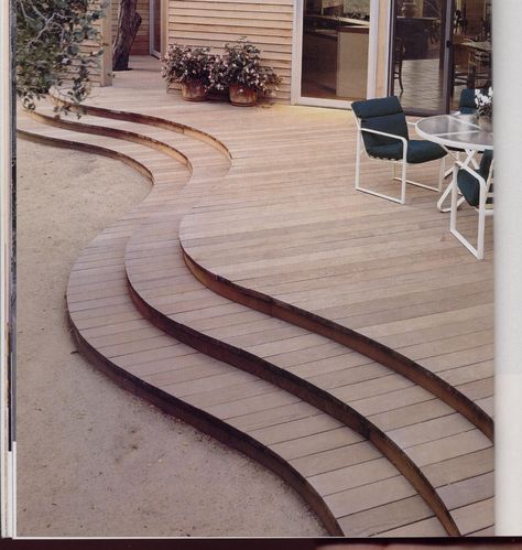 Wooden decks can be an immediate extension of a house or a remote space overlooking a particularly spectacular vista and be designed in many shapes and sizes.  This one bows where it needs to, where a table and chairs need more room than circulation. Curved Patios, Curved Front Porch, Decking Path, Curved Decks, Round Terrace, Curved Decking, Wood Deck Steps, Curved Deck, Curved Patio