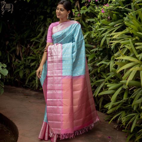 This ilam neelam Kanchipuram silk saree is woven with silver buttas all over and is paired with a contrasting ilam roja border with rettai naagam silver zarigapettu. #sarees #kanchipuram #kanchipuramsilk #kanchipuramsilksaree #kanchipattu #bridalwear #festivewear Pastel Kanchipuram Saree, Blue Silk Saree, Kanjivaram Sarees Silk, Bridal Sarees South Indian, Beautiful Sarees, South Indian Sarees, Sarees Silk, Trendy Blouse, Bridal Silk Saree