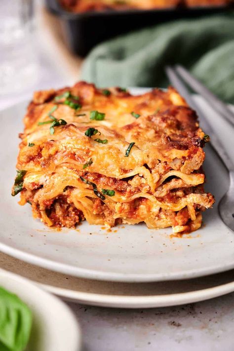 A close-up of a slice of lasagna on a white plate, garnished with chopped green herbs. A fork rests beside the plate. Air Fryer Lasagna, Best Vegetarian Lasagna, Vegetarian Lasagna Recipe, Best Lasagna Recipe, Baked Lasagna, Beef Lasagna, How To Make Lasagna, Lasagna Ingredients, Healthy Veggie