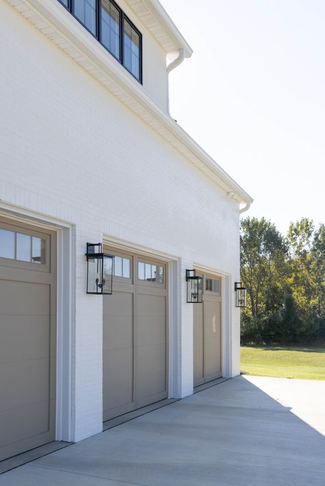 Cream House Black Garage Door, Light Brick And Siding Exterior, Sandstone Garage Door, Farmhouse Garage Door Ideas, 2024 Exterior House Colors, Limewash House, Grey House Exterior, White House Exterior, White Garage Doors