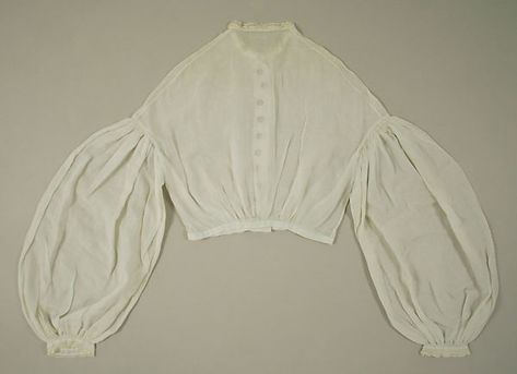 c.1860 white waist (back view) in cotton with small black buttons of unidentified material and lace at wrist and neck. You can see the sheerness in this back view. Met Museum. [jrb] 19th Century Dresses, 19th Century Dress, Victorian Blouse, Century Dress, Costume Institute, Historical Costume, Historical Dresses, Historical Clothing, Blouse Pattern