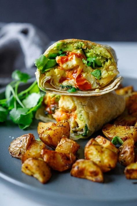 These savory California-style, vegetarian breakfast burritos are filled with roasted poblano peppers, soft scrambled eggs (or tofu), roasted potatoes, avocado, melty cheese, hot sauce and cilantro. Vegan-adaptable. California Breakfast Burrito, Soft Scrambled Eggs, California Burrito, Vegetarian Burrito, Vegan Breakfast Burrito, Roasted Poblano Peppers, Roasted Poblano, Breakfast Burritos Recipe, Poblano Peppers