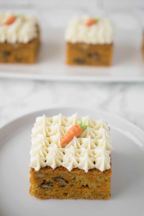 An easy carrot cake made sheet cake style and cut into squares. These carrot cake squares are perfect individual sizes with added walnuts and adorned with decoratively piped cream cheese frosting. #easycarrotcake #creamcheesefrosting #easter Square Carrot Cake, Cake Squares, Carrot Cake Bars, Cake Recipes At Home, Cake Style, Moist Carrot Cakes, Easy Carrot Cake, Square Recipes, Individual Desserts