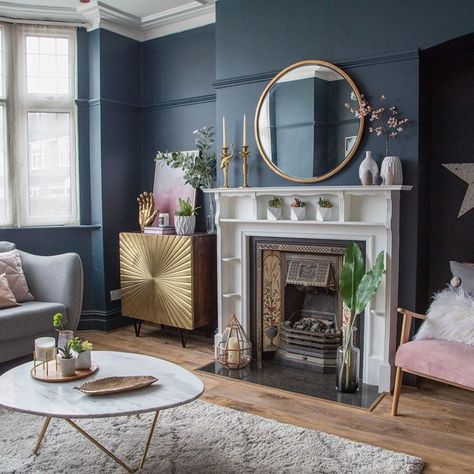 Living room makeover with dark blue walls, pink sofa and gold accessories  Dark coloured walls for Kate Beavis Your Vintage Life, vintage blogger, writer and speaker on homes, fashion, weddings and lifestyle. #darkwalls #bluewalls #wallpaper #paint #home #alternative #decor #design #yourvintagelife Dining Fireplace, Blue And Gold Living Room, Rosa Sofa, Blue Walls Living Room, Fire Surrounds, Navy Living Rooms, Quilted Cushion, Victorian Living Room, Gold Living