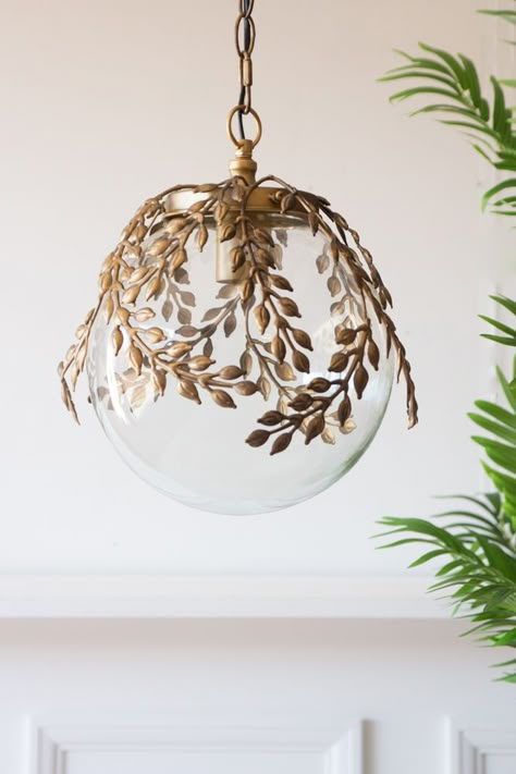 Lifestyle image of the Ornate Globe Pendant Ceiling Light With Brass Leaf Detailing with a table below Glass Pendant Shades, Glass Globe Pendant Light, Globe Ceiling Light, Rockett St George, Ceiling Light Shades, Vintage Pendant Lighting, Globe Pendant Light, Glass Ceiling Lights, Bedroom Ceiling