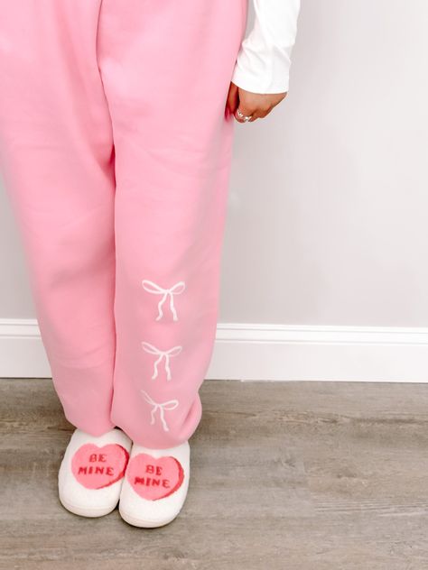 We are so excited to release our newest Sassy Shortcake merch item! The Blushing Bow Sassy Sweatpants are pink and feature three white bows text. These sweats feature an elastic waistband and pockets for maximum comfort, and feature a soft micro-fleece lining. Rep your favorite brand in these super cute pants!! Also available in blue and grey. fits: true to size, model wearing a size small content: 100% polyester care: hand wash cold Cute Pink Hoodies, Pink Wishlist Ideas, Trendy Pink Relaxed Fit Sweatpants, Pink Letter Print Sweats With Relaxed Fit, Pink Letter Print Crew Neck Sweats, Preppy Sweatpants, Sweatpants Ideas, Bow Sweatpants, Baby Pink Sweat Pants