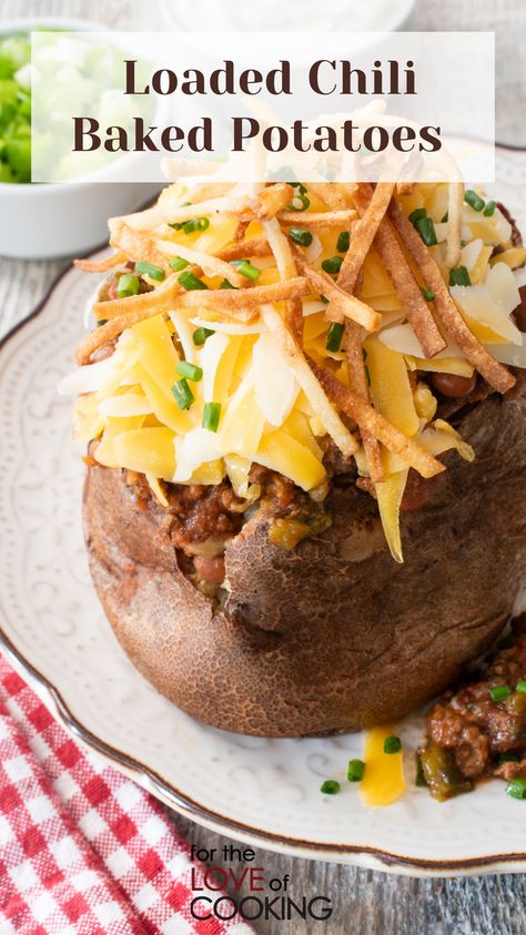 These loaded chili baked potatoes are tender, fluffy potatoes filled with spicy chili and topped with all your favorite toppings. #recipe #bakedpotato #chili #potatoes #loadedpotato #easyrecipes #gamedayfood #footballfood Chili Potatoes, Loaded Chili, Fluffy Potatoes, Chili Baked Potato, Chili Bake, Steak Chili, Poblano Chili, Baked Potato Bar, Stuffed Baked Potatoes