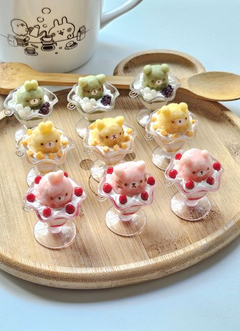 Handmade realistic fruit parfait keychains made with sturdy Japanese air dry clay. Comes in mango, strawberry, or matcha, and as a bunny, bear, or cat ice cream on top. Has been glazed with a water resistant varnish for added protection. Comes with a phone strap with a matching color. They are about 2 inches in length. Would look super cute on any bag or purse for that little touch of added cuteness :) Cute Japanese Things, Cute Parfait, Cute Polymer Clay Charms Kawaii, Kawaii Charms Jewelry For Gift, Handmade Polymer Clay Kawaii Jewelry, Mofusand Wallpaper Strawberry, Cat Ice Cream, Fake Sweets, Kawaii Resin Charms