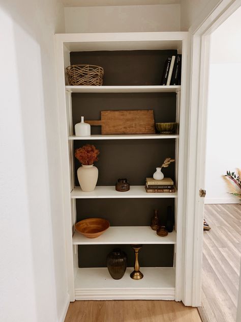 Hallway, bookshelf styling, bookshelf decor ideas, black paint, neutral decor Shelves At End Of Hallway, End Of Hallway Storage, End Of Hallway Bookcase, Hall Bookshelf Ideas, End Of Hall Bookshelf, End Of Hallway Shelves, End Of Hallway Bookshelf, Backless Bookshelf, Shelf In Hallway