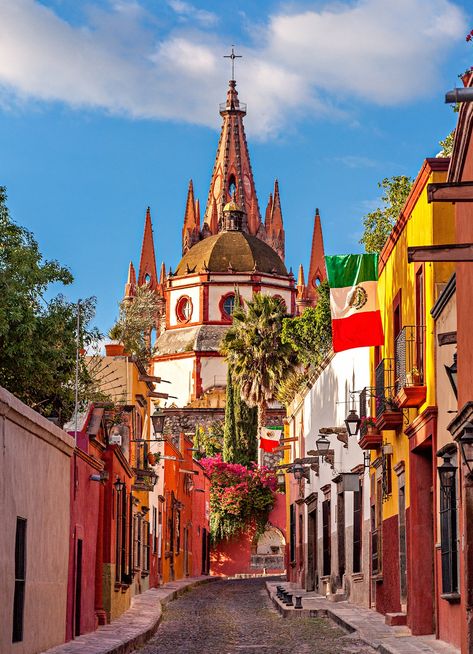 The historic and colorful Aldama Street in San Miguel De Allende is a must-see for any traveler heading to centrally located Mexican city. Roughly 170 miles north of Mexico City, San Miguel De Allende was voted the "2013 Best City in the World" by Travel + Leisure. Aloita Resort, Visit Mexico, Beautiful Streets, Mexican Culture, Cozumel, Machu Picchu, Mexico Travel, Travel Inspo, America Travel