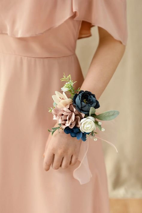 The elegant wrist corsages are made of foam dusty rose gardenia, navy blue petite peony, and ivory ranunculus, accented with lambs ear leaf, and pearl floral pick. Wrist corsage with dusty rose silk bands, easy to wear, comfortable, and firm, fits most wrist sizes. #wrist_corsage #corsage_bracelet #corsage_wristbands #wedding_accessories Corsages For Wedding, Bridesmaid Wrist Corsage, Mother Of Bride Corsage, Wedding Mother Of Bride, Wrist Corsage Bracelet, Wrist Corsages, Rose Corsage, Wrist Flowers, Vintage Wedding Decorations