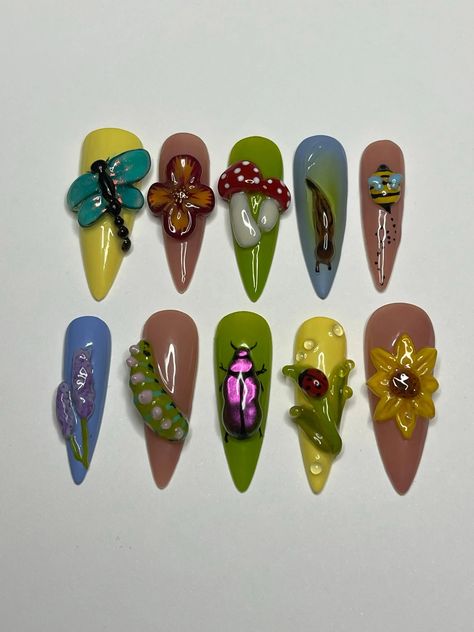 Explore our 3D Lively Garden Fake Nails, crafted with a charming handmade design of flowers and bugs. Available in short and long lengths, these vibrant nails add a whimsical touch to your look. Perfect for those who appreciate unique, glue-on false nails that stand out with creativity. 📦 What comes with your press on nail kit? 10 nails of your size 24 adhesive tabs 1 nail file 1 cuticle stick Instructions on how to apply and remove them. Finding Your Size:Check out our sizing chart or Visit ou Green Theme Nails, Plant Nails Design, Vegetable Nails, Garden Nails Design, Caterpillar Nails, Fairy Garden Nails, Junk Nail Designs, Patch Nails, Dragonfly Nails