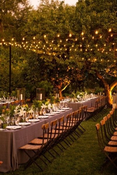 Christmas lights – Everyone knows about christmas lights being used as decoration for the holiday season, but the white lights actually add an amazingly beautiful gold hew to patios in need of some visibility. Hanging them over head is a great way to bring your eyes up and not worry about stepping on the wires on the ground. Forest Wedding Reception, Outdoor Wedding Lighting, Wedding Reception Lighting, Deco Champetre, Long Tables, Napa Valley Wedding, Outdoor Wedding Reception, Outdoor Reception, Tables And Chairs